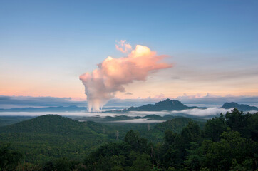 Beautiful sea of fog in the mountains, high voltage pole and steam from the coal power plant in the morning sunrise . Mae moh, Lampang, Thailand. Energy and environment concept .
