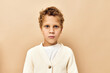 © SHOTPRIME STUDIO - boy with curly hair in white sweater studio