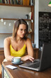 © ksenija1803z - Portrait of businesswoman working on laptop remotely in cafe