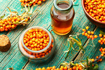 Sea buckthorn in glass bottle