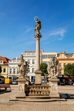 Kolin, Central Bohemia, Czech Republic, 10 July 2021: Baroque Marian Column Sandstone Sculptural Group With Statues Of Four Saints On Charles Square In Medieval Town Center At Sunny Summer Day