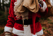 Mid Section Of Person Wearing Santa Costume
