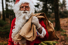 Man Wearing Santa Costume Carrying Sack