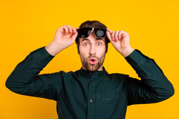 Poster - Photo of shocked impressed young man wear smart casual outfit arms dark glasses isolated yellow color background