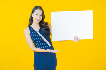 Wall Mural - Portrait beautiful young asian woman with empty white billboard