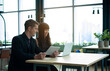 © StreetOnCamara - ฺีBusinessman and businesswoman manager boss executive company office at co working space talk discussion interview partnership together look at computer notebook tablet investment customer job online