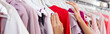© LIGHTFIELD STUDIOS - partial view of woman choosing clothing in boutique, banner