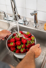 Strawberries Being Washed In Sink 