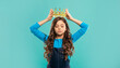 © be free - selfish kid with curly hair in princess crown on blue background, egoist