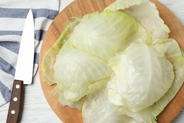 Cooked leaves for stuffed cabbage roll on white wooden table, flat lay