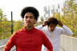 © ADDICTIVE STOCK - Ethnic guys walking near street railings