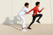 © ADDICTIVE STOCK - Black guy catching jogging friend on street