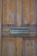 Worn Wooden Door And Brass Mail Slot