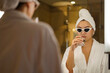© ABWitzPix089 - Asian young woman wearing sunglasses in a bathrobe and hair wrapped in towel holding  a drinking glass with clear water at the mirror in the bathroom