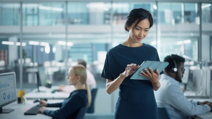 Aufkleber - Successful Businesswoman in Stylish Dress Using Tablet Computer, Standing in Modern Diverse Office Working on Financial, Business and Marketing Projects. Portrait of Beautiful Asian Manager.
