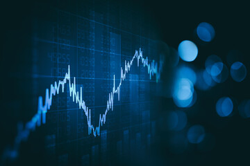 Close up financial chart with uptrend line graph in stock market on defocused blue color bokeh background