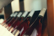 Rose wine bottles stacked on wooden rack.