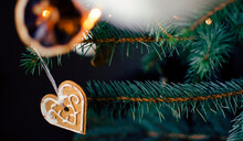 Christmas With Green Branch Of Fir With Christmas Decoration. Gingerbread Heart Hanging On A Branch. Christmas Card. Banner.