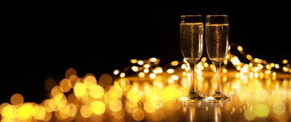 Two glasses of champagne on a background of bokeh lights, 2022 new year