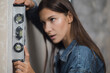 © kalinichenkod - The joyful girl uses the balance ruler to measure. Renovation in a new apartment