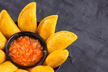 Wall Mural - Fried empanadas with spicy sauce - typical Colombian food