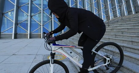 Wall Mural - Woman free rider riding down city stairs, slow motion