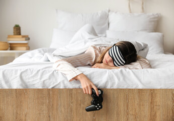 Sticker - Morning of sleepy young woman with video games controller lying in bed