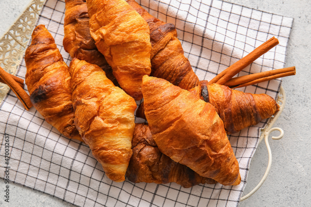 Tray with delicious croissants on white background