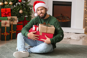 Poster - Happy man with Christmas gifts at home