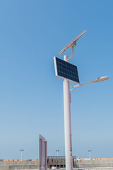 Two solar panels attached to top of lamppost