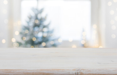 Wall Mural - empty wooden table in front of blurred winter festive background