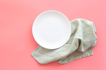 Wall Mural - Empty plate on napkin - table setting for dinner. Overhead view