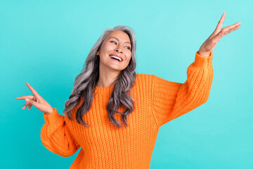 Photo of senior excited lady good mood enjoy event wondered look empty space isolated over turquoise color background