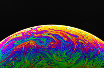 Wall Mural - Virtual reality space with abstract multicolor psychedelic planet. Closeup Soap bubble like an alien planet on black background.