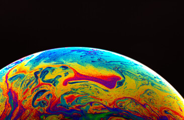 Wall Mural - Virtual reality space with abstract multicolor psychedelic planet. Closeup Soap bubble like an alien planet on black background.
