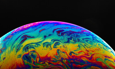 Wall Mural - Virtual reality space with abstract multicolor psychedelic planet. Closeup Soap bubble like an alien planet on black background.