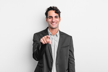 young businessman pointing at camera with a satisfied, confident, friendly smile, choosing you