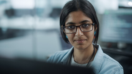 Diverse Office: Portrait of Empowered Indian IT Programmer Working on Desktop Computer. Female Specialist Wearing Glasses Create Innovative Software. Professional Engineer Develop Inspirational App