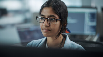 Wall Mural - Diverse Office: Portrait of Confident Indian IT Programmer Working on Desktop Computer. Female Specialist Wearing Glasses Create Innovative Software. Professional Engineer Develop Inspirational App