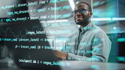Real Office: Professional Black IT Programmer Working on Desktop Computer. Male Website Developer and Software Engineer Developing App, Video Game. Shot with Visual Effects of Running Code.