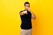 © luismolinero - African American man over isolated background with fighting gesture