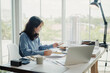 © VStudio - Selective focus, Asian female architect or engineer Currently considering materials for designing modern condominiums. Asian female architect or engineer Sit and analyze, design projects in the office