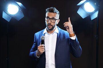 Wall Mural - Motivational speaker with microphone performing on stage