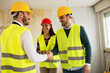 © didesign - Engineers shaking hands at the construction site