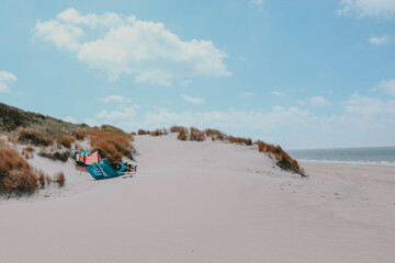 A kite and a foil lie lonely on the beach somewhere in the Netherlands