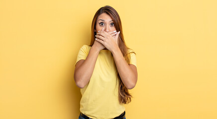 Wall Mural - asian pretty woman covering mouth with hands with a shocked, surprised expression, keeping a secret or saying oops