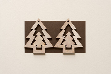 two christmas tree ornaments on paper