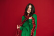 © Drobot Dean - White woman laughing while posing with Christmas tinsel garland