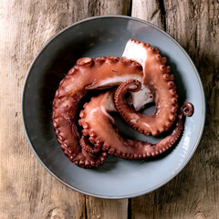 Wall Mural - Coocked tentacles of octopus on ceramic plate