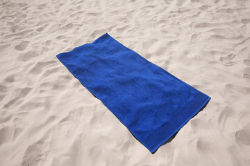 Wall Mural - Beautiful soft blue beach towel on sand